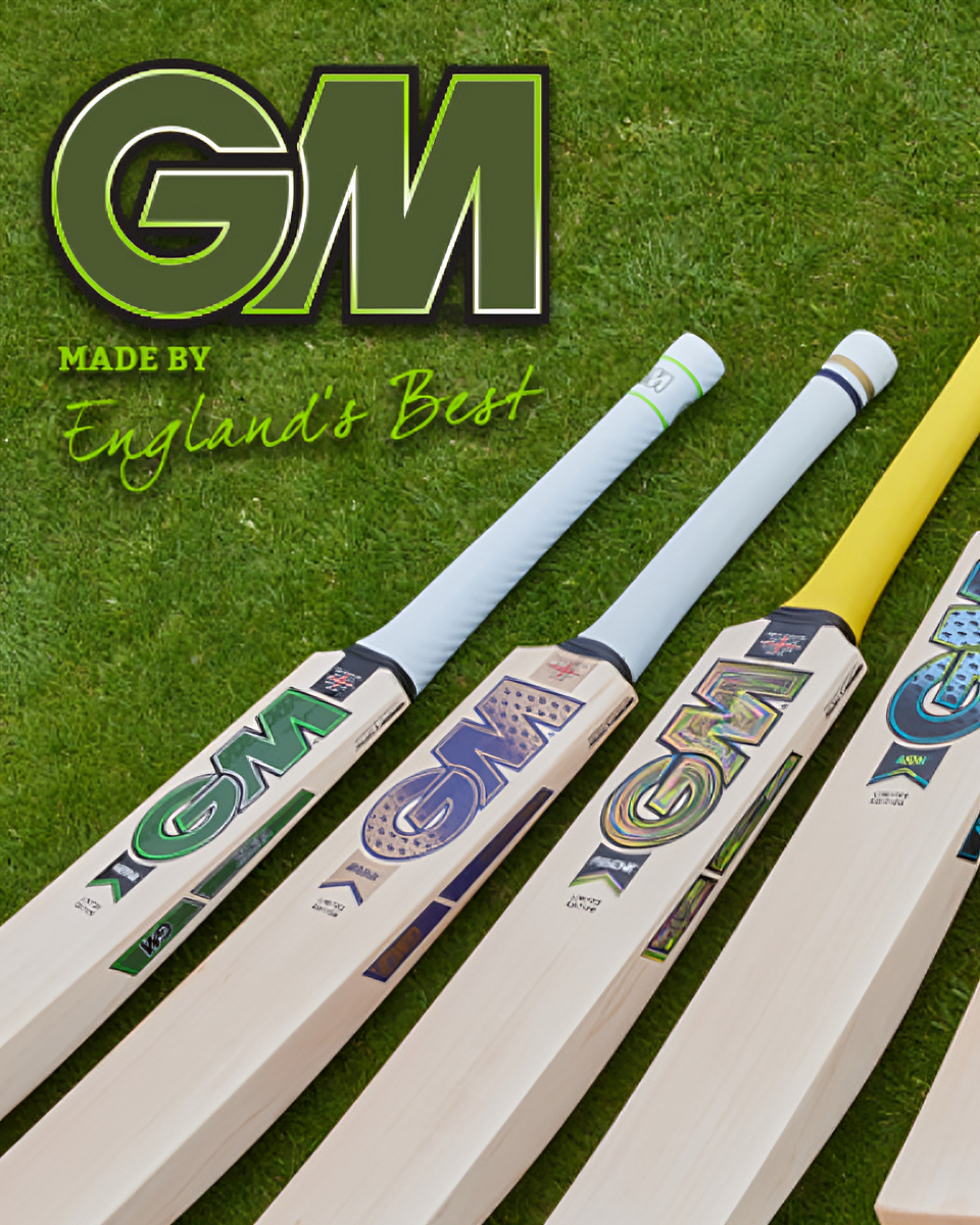 Three cricket bats with GM branding on a grass background